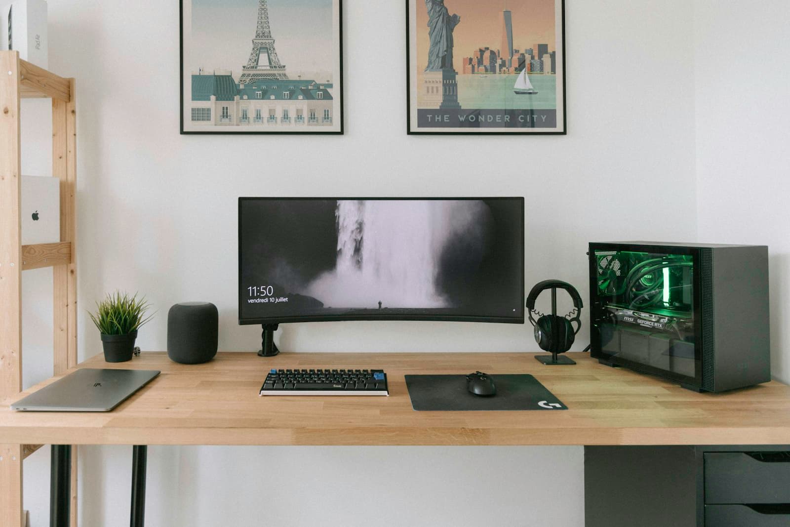 Minimal desk with an ultrawide monitor and a small plant